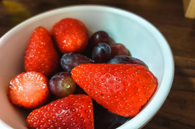 High angle view of strawberries in bowl on table