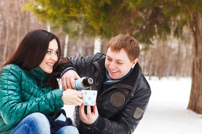 Portrait of smiling young woman on snow