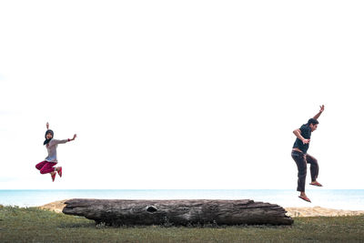 Young woman jumping in sea