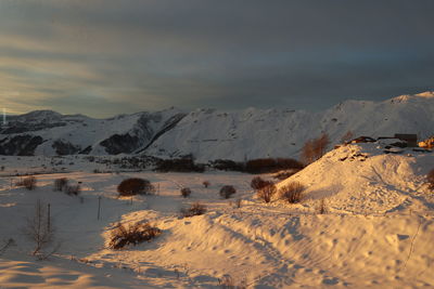 Scenic view of snow covered mountains against sky