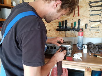 Side view of man working at workshop