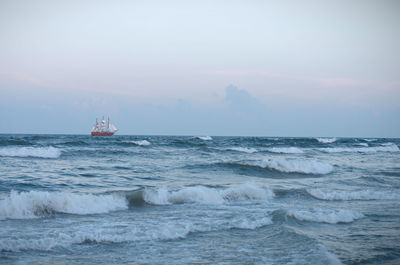 Sailboat sailing on sea against sky