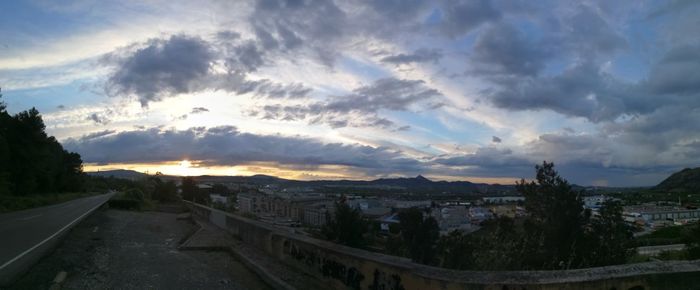 Panoramic view of city against sky during sunset