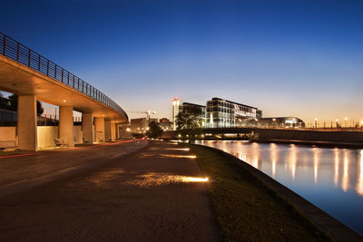 Illuminated bridge in city at night