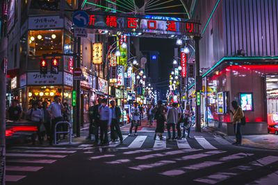 People on city street at night