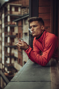 Portrait of young man sitting at home