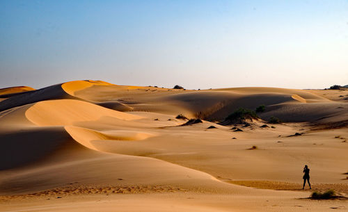 Scenic view of desert against clear sky