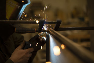 Welding work. sparks from welding metal. production details. creating seam.