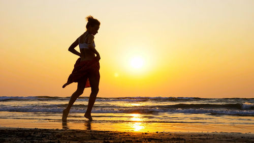 Full length of man on beach during sunset