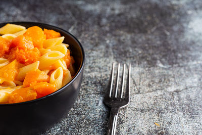 Penne pasta with pumpkin, typical autumn food. ideal for vegan and vegetarian people.