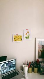 Potted plant on table against wall