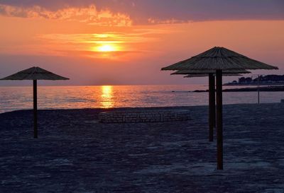 Lifeguard hut on beach during sunset