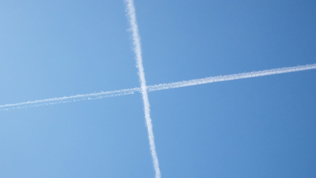 LOW ANGLE VIEW OF VAPOR TRAILS IN SKY