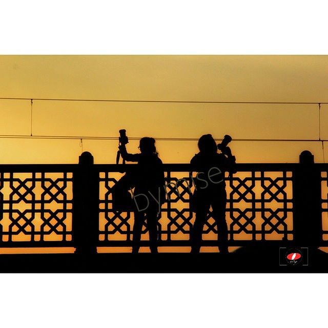 men, lifestyles, leisure activity, togetherness, silhouette, person, full length, transportation, transfer print, bicycle, standing, walking, railing, auto post production filter, bonding, sky