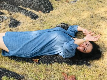 High angle view of child lying on land