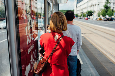 Rear view of women walking on street in city