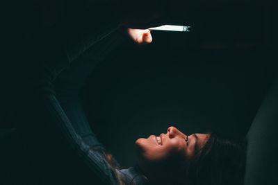 Cropped image of hand against black background