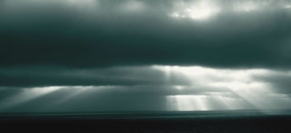 Scenic view of sea against storm clouds