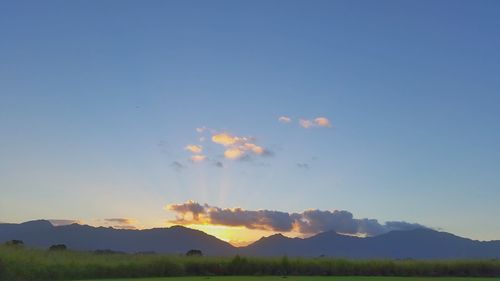 Scenic view of mountains against sky at sunset