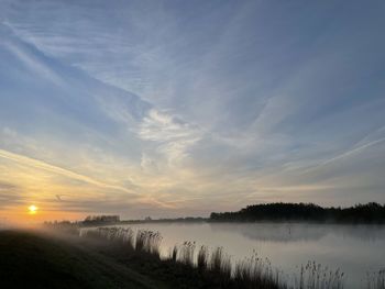 Scenic view of lake against sky during sunset