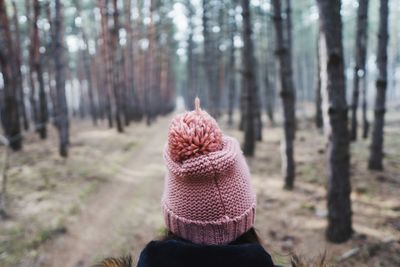 Woman wearing knit hat in forest