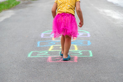 Low section of woman walking on road