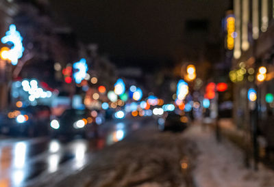 Defocused image of illuminated city street at night