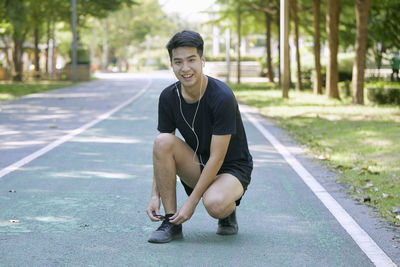Portrait of young man sitting on floor