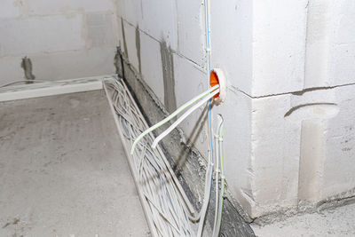 Layed installation of electric cables on the floor in a newly built house. cables lying in plastic