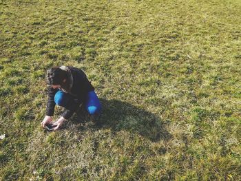 High angle view of person sitting on field