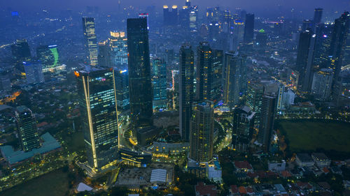 Aerial view of illuminated buildings in city