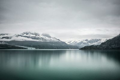 Scenic view of lake and snowcapped mountains