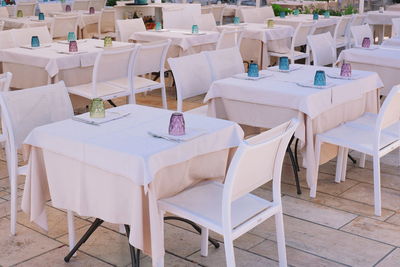 Empty chairs and tables in restaurant