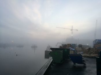 Boats moored in sea during foggy weather