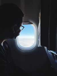 Man looking through window