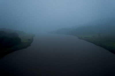 Scenic view of mountains against sky during foggy weather