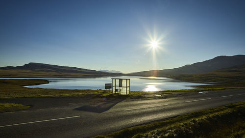 Scenic view of lake against bright sun