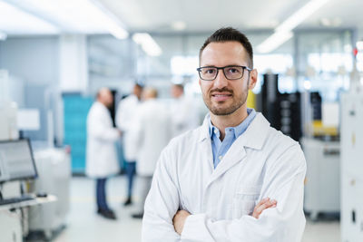 Portrait of young man standing in laboratory