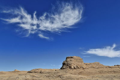 Low angle view of rock formations against blue sky