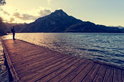 Rear view of person on sea shore against sky