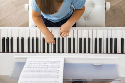 High angle view of girl playing piano