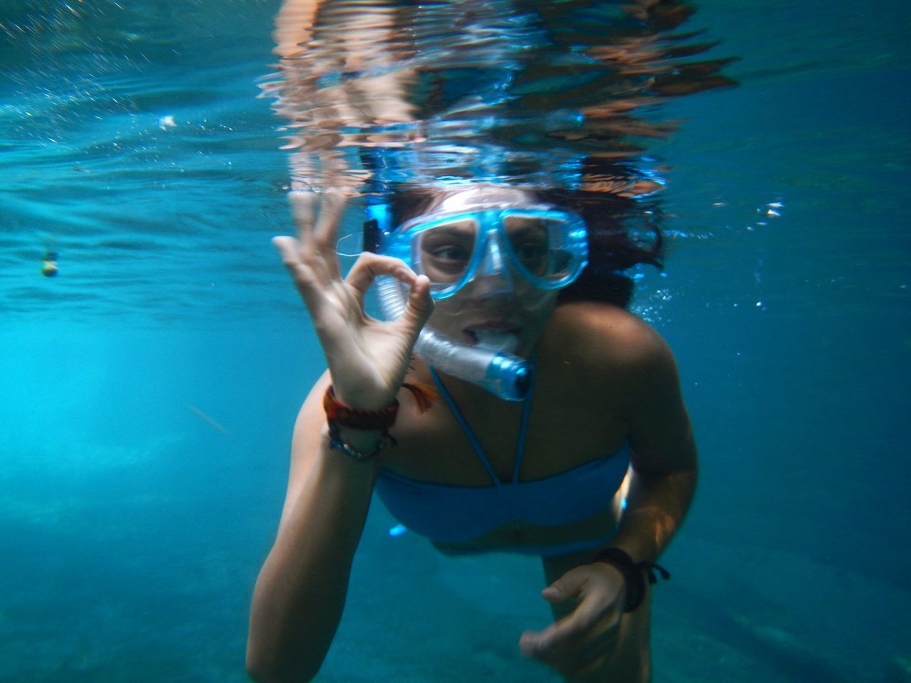 YOUNG WOMAN SWIMMING IN SEA