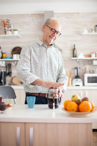 Senior man preparing coffee at home