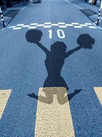 Shadow of woman on road