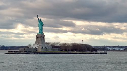 Statue of liberty against cloudy sky