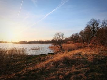 Scenic view of lake against sky during sunset