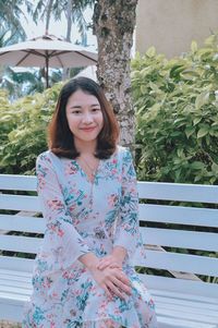 Portrait of smiling young woman standing outdoors