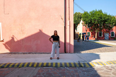 Full length rear view of man walking on street