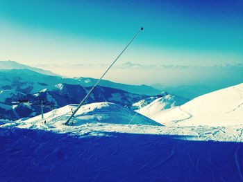 Scenic view of snow covered mountains against sky