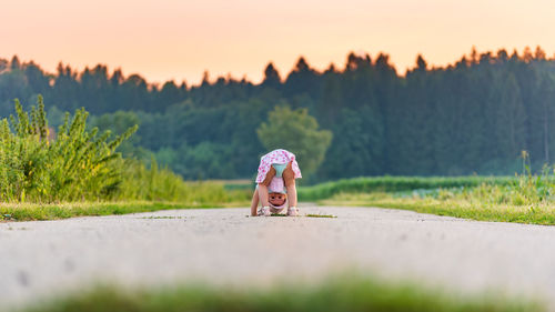 Rear view of woman walking on field